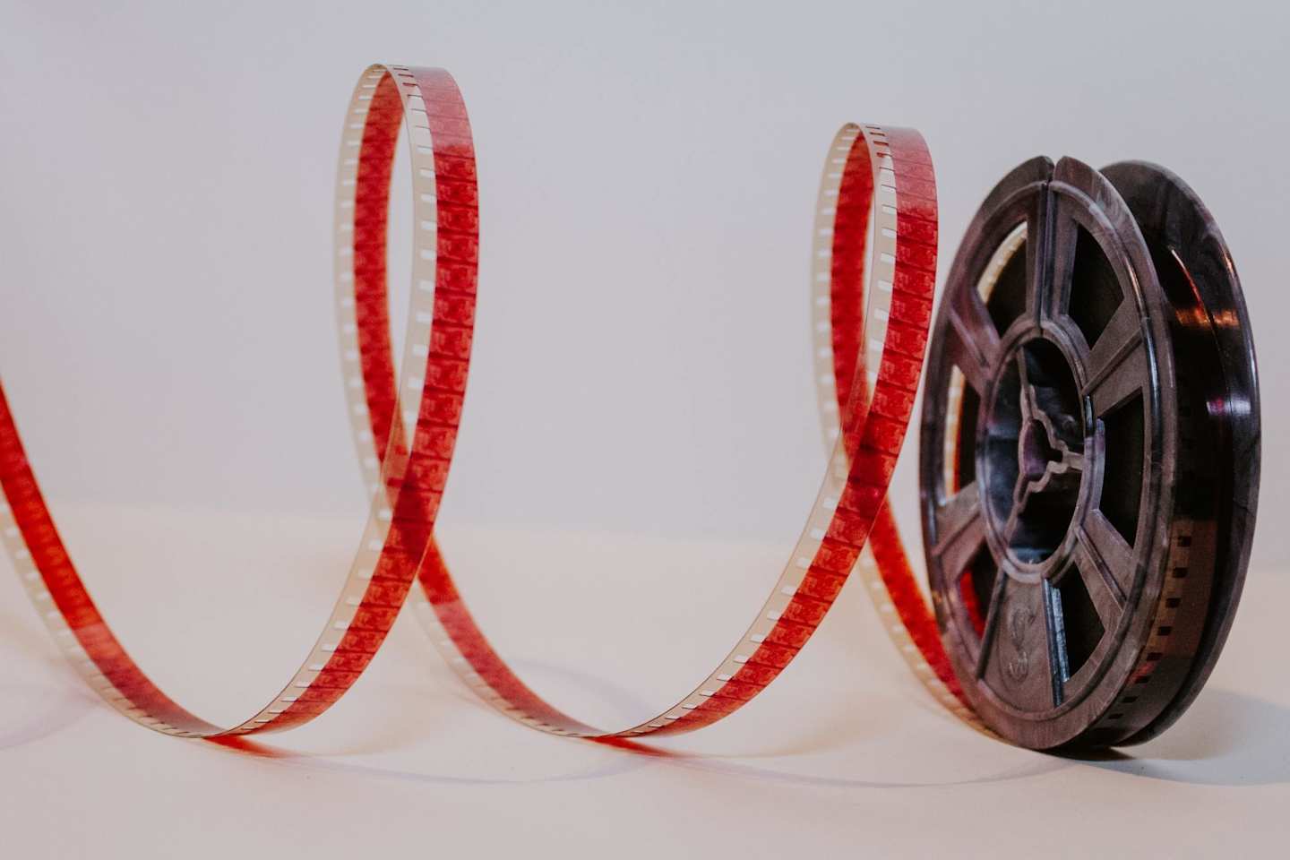A reel of film tape in a white room