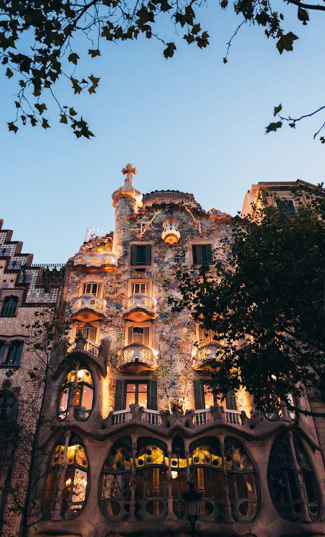 A low-angle view of Casa Battlo lit up in the evening, Passeig de Gràcia, Barcelona, Spain