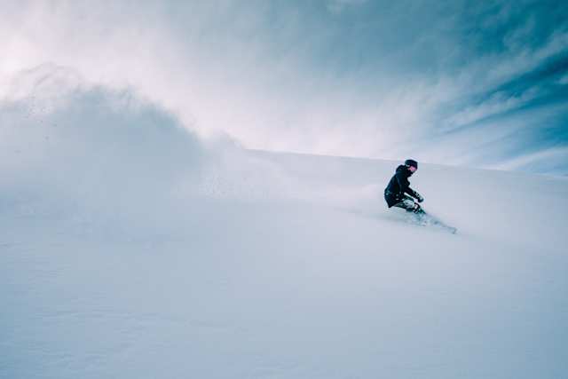 Person snowboarding down a snowy mountain