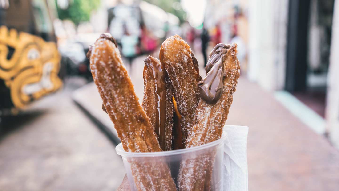 Churros with chocolate in a cup