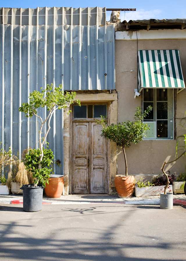 neve tzedek neighbourhood in tel aviv street scene with tree and wooden door