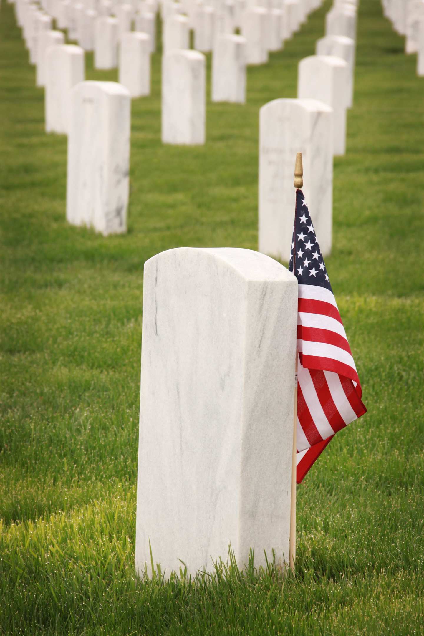 Tombstone with USA flag at Woodlawn Cemetery, New York
