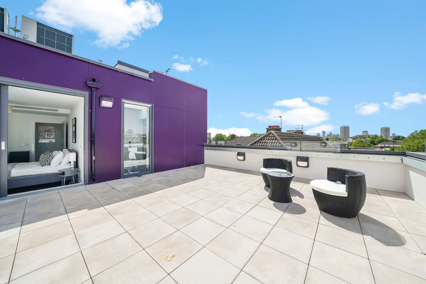 Two seats on the private rooftop terrace at Skyline Dreaming, Plum Guide home in London, UK