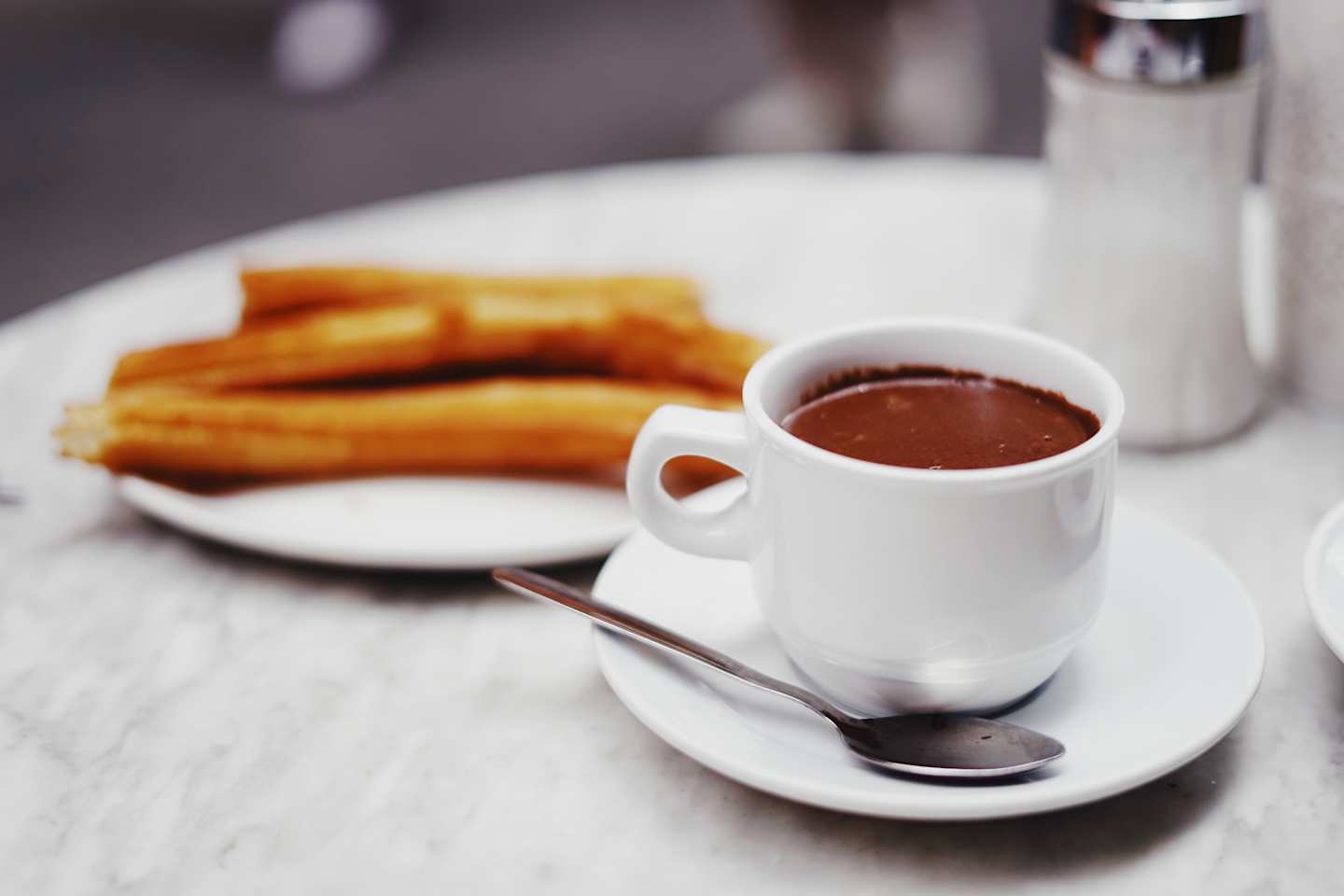 Churros with a cup of melted chocolate
