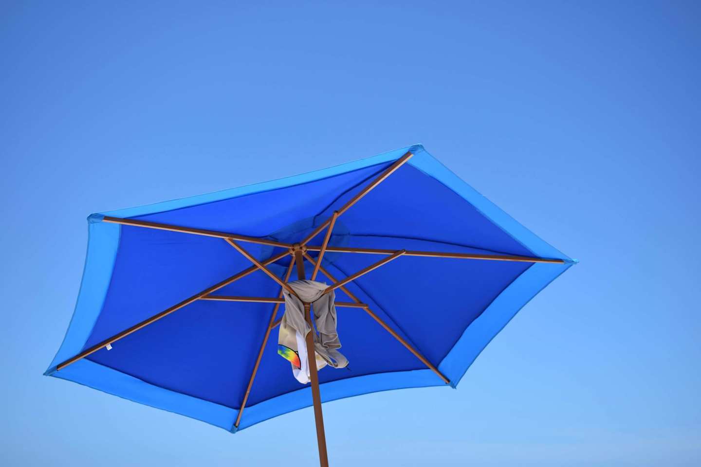 Low angle shot of a blue parasol, opened up at the beach