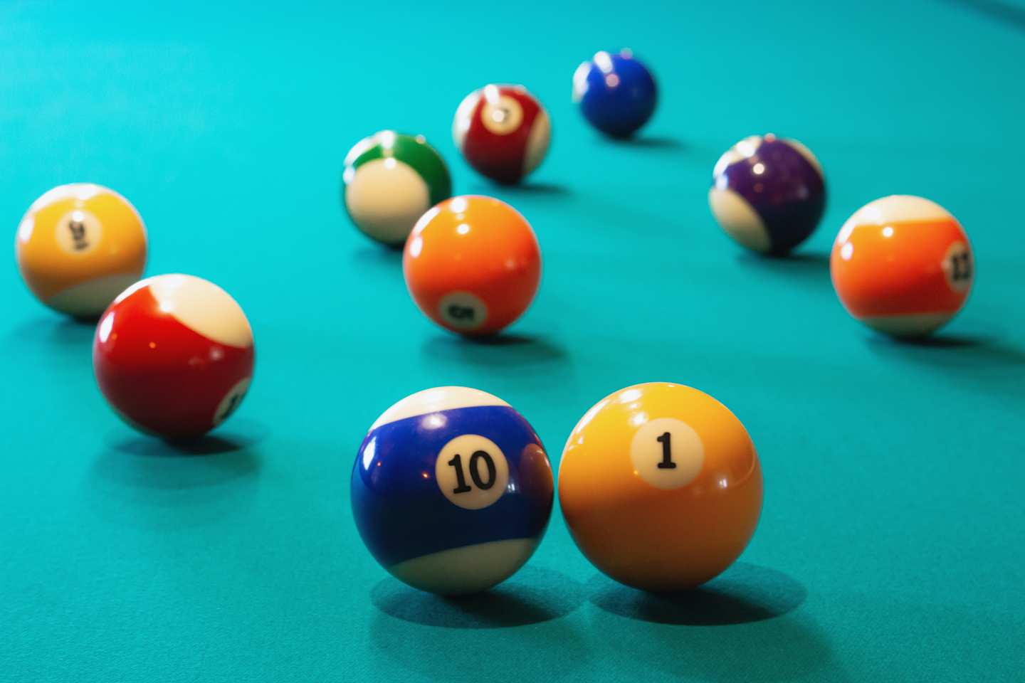 A close up view of multiple balls on a pool table