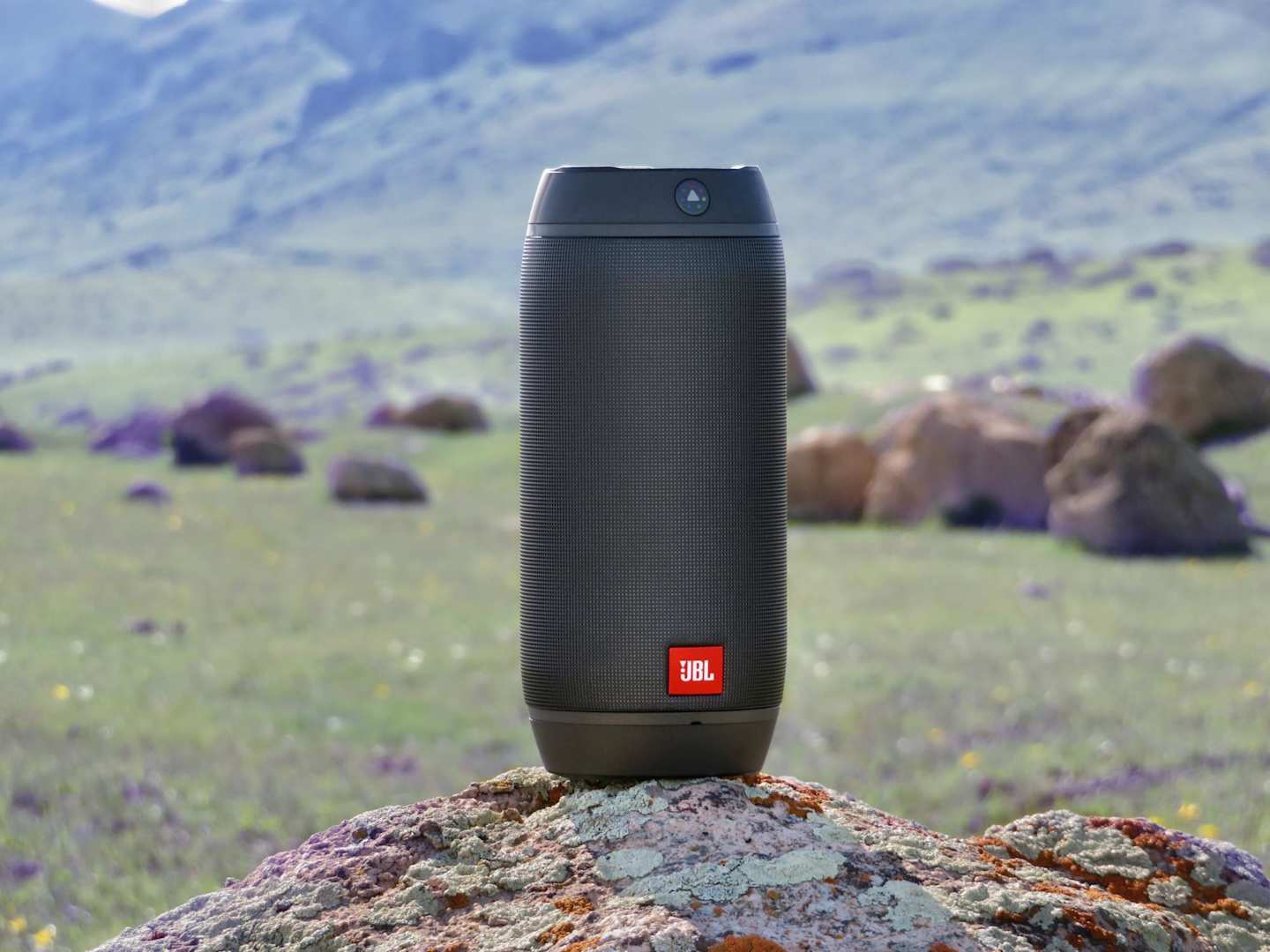 Close up of a small black speaker outdoors in the countryside