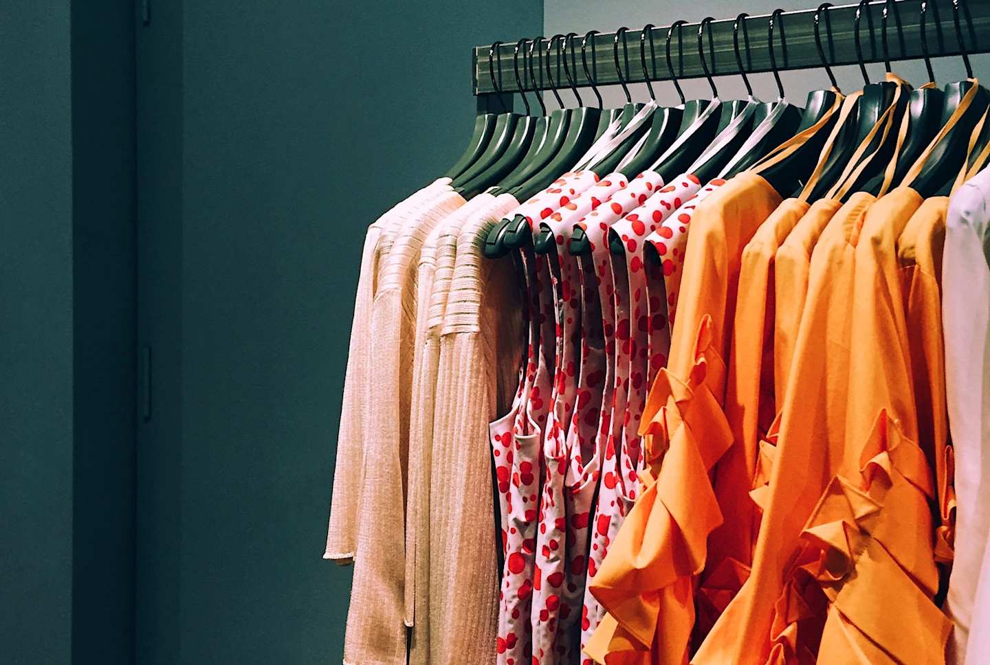 Pink and orange clothes on a rail