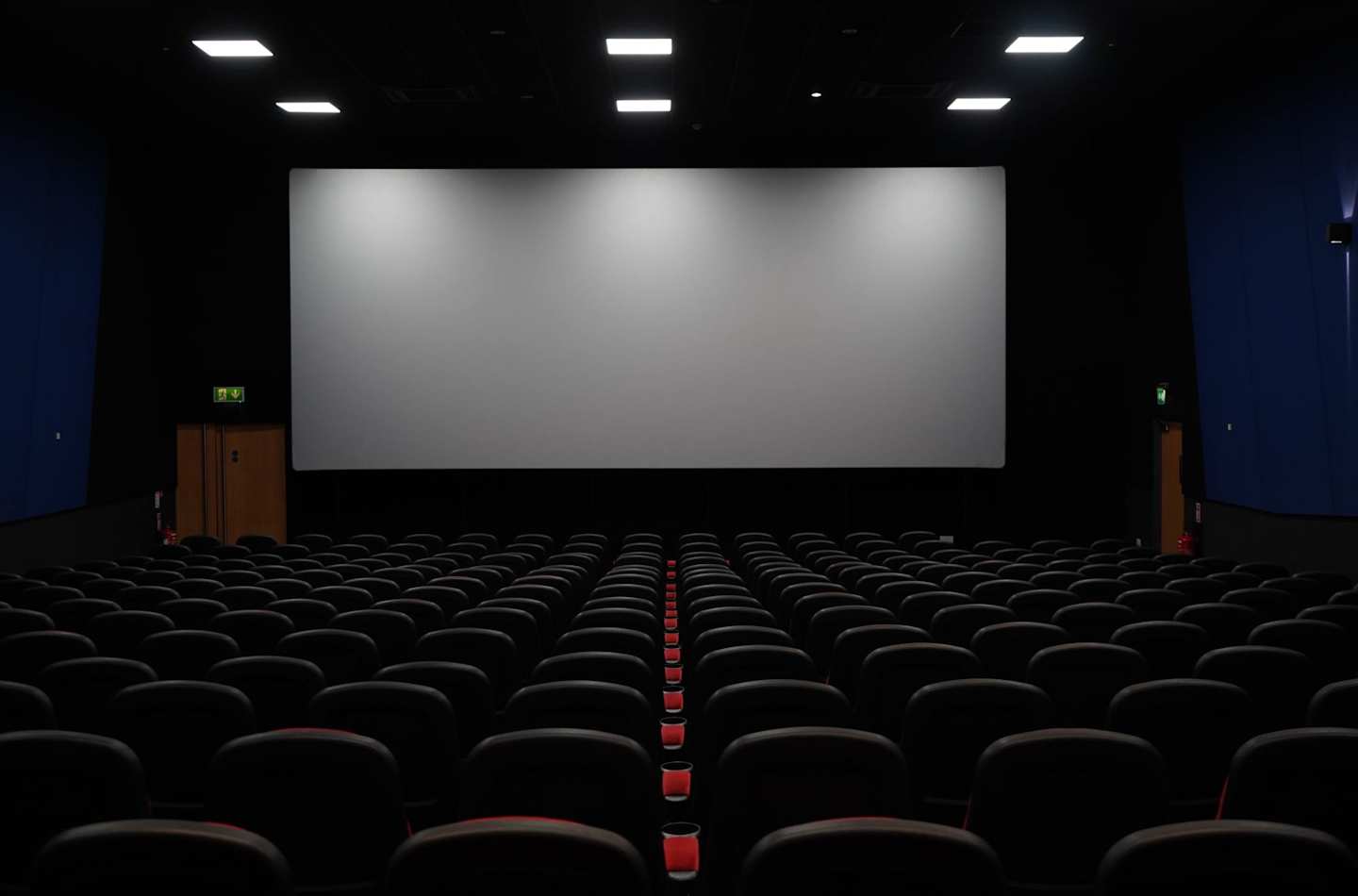A blank screen in an empty cinema theatre