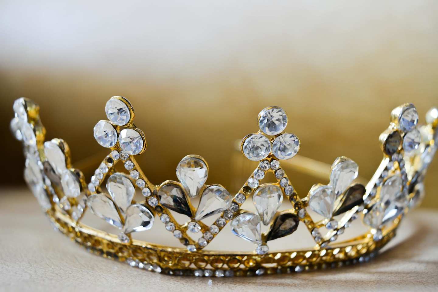 Close up of a gold tiara with clear diamonds