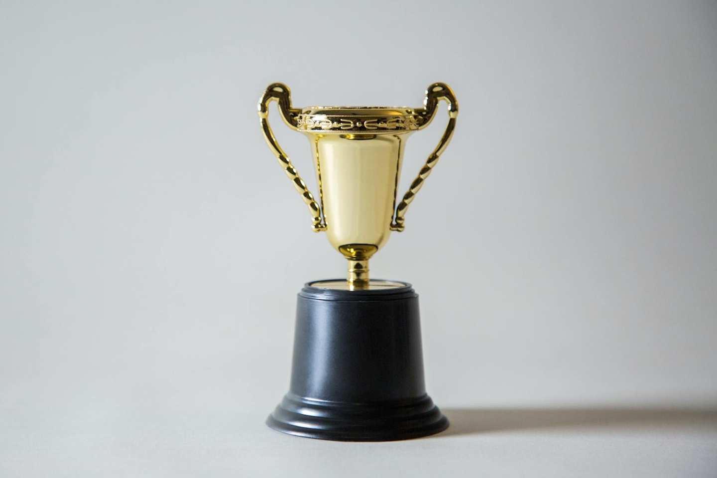 gold and black trophy on white background