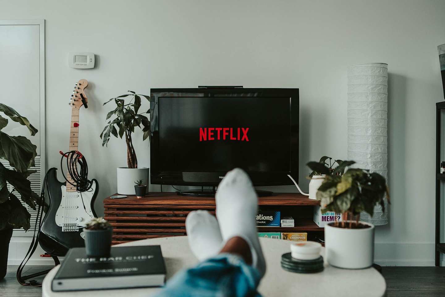 A person watching television with Netflix showing on the screen