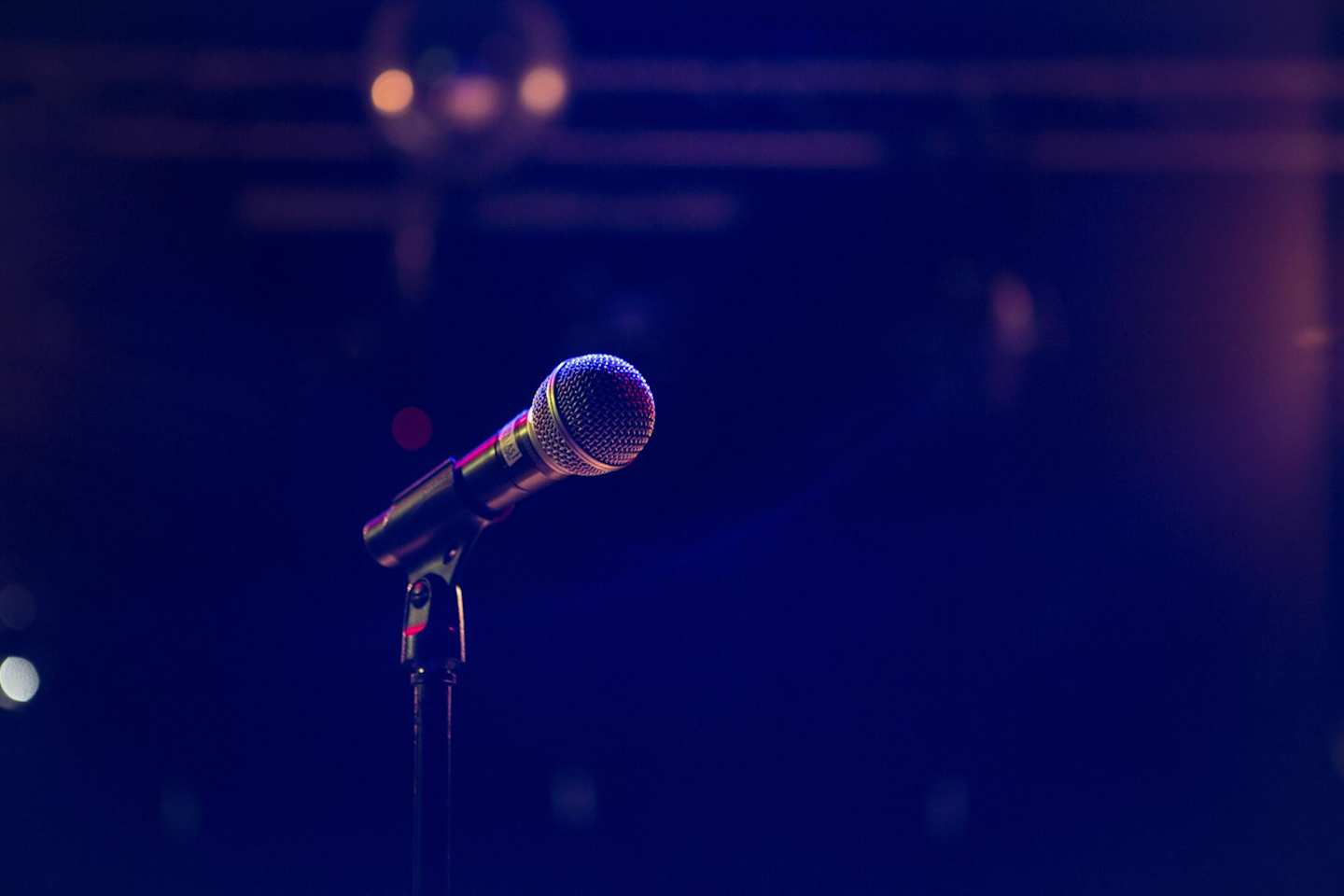 A microphone stand on a stage holding a microphone