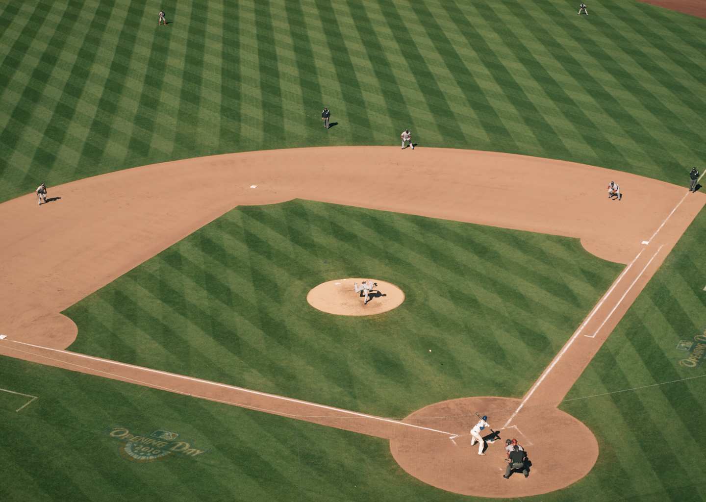 People playing baseball on field during daytime