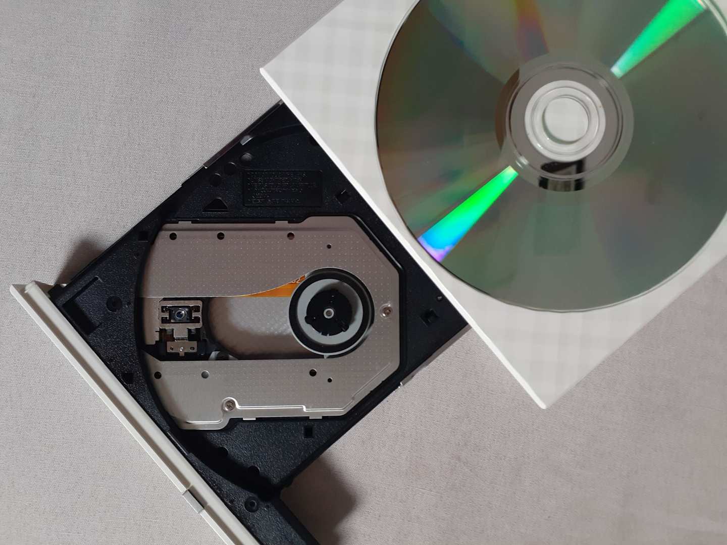 A close up of a dvd player with a silver dvd