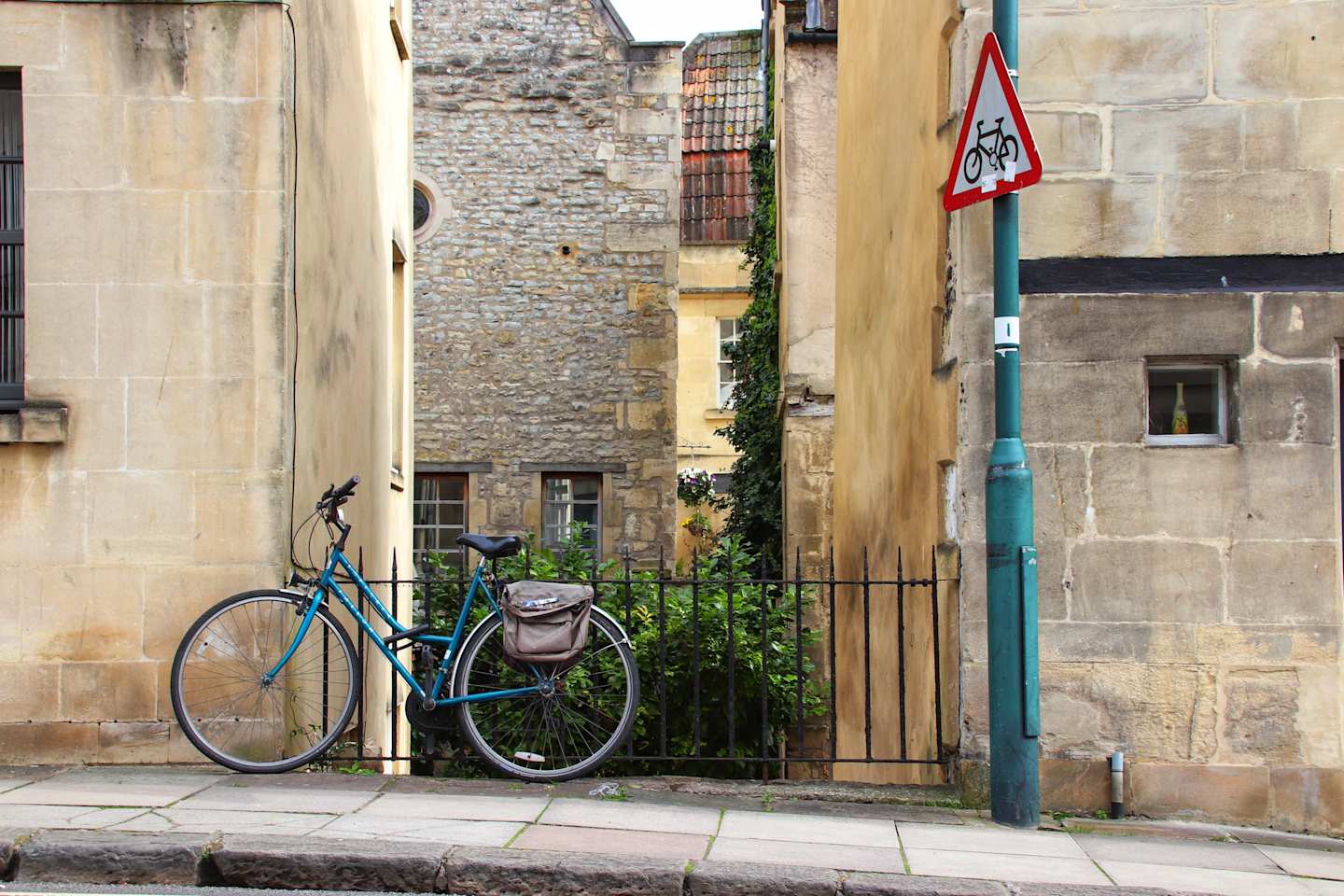 Bicycle standing against a fence along a path in Bath, UK