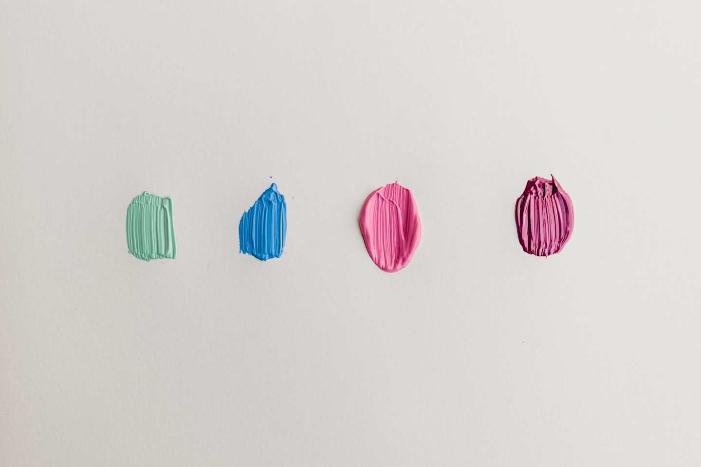 Four spots of different coloured paint on an easel