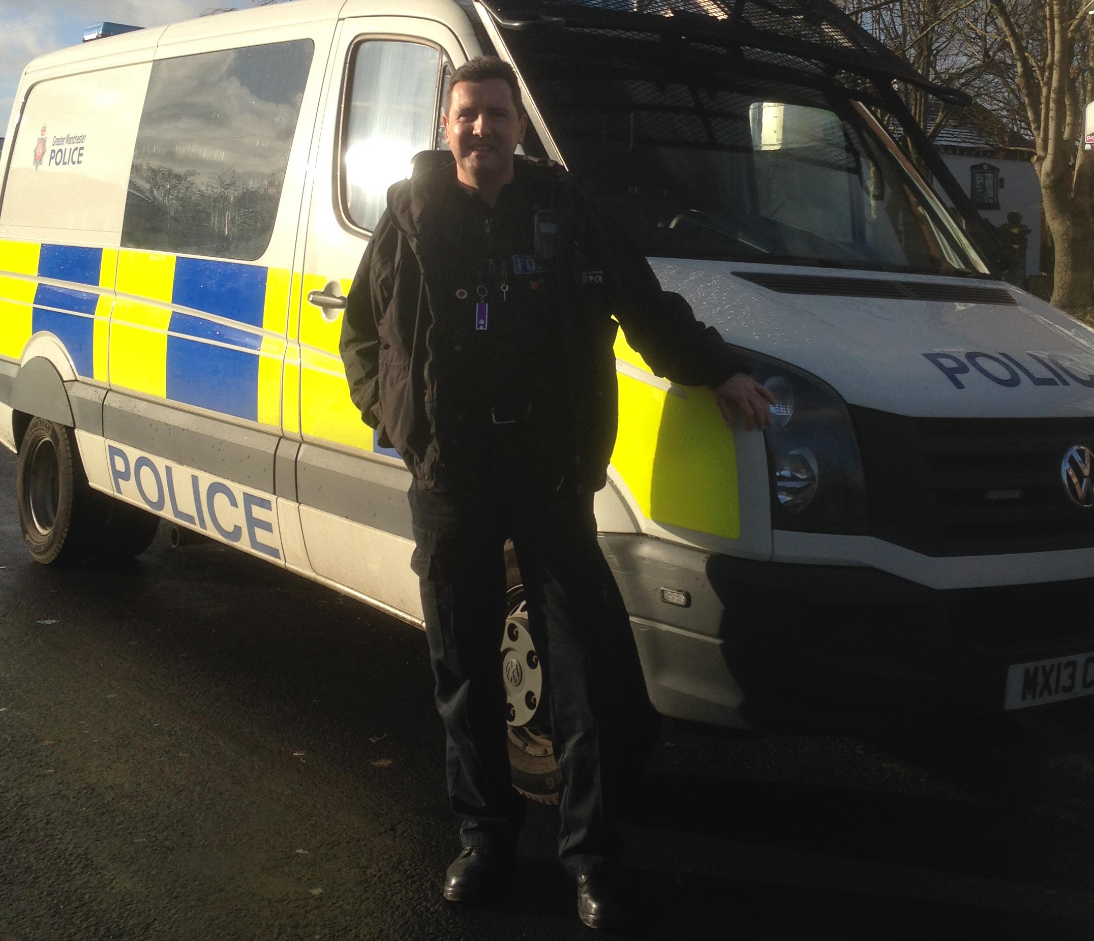 Man standing next to a police van
