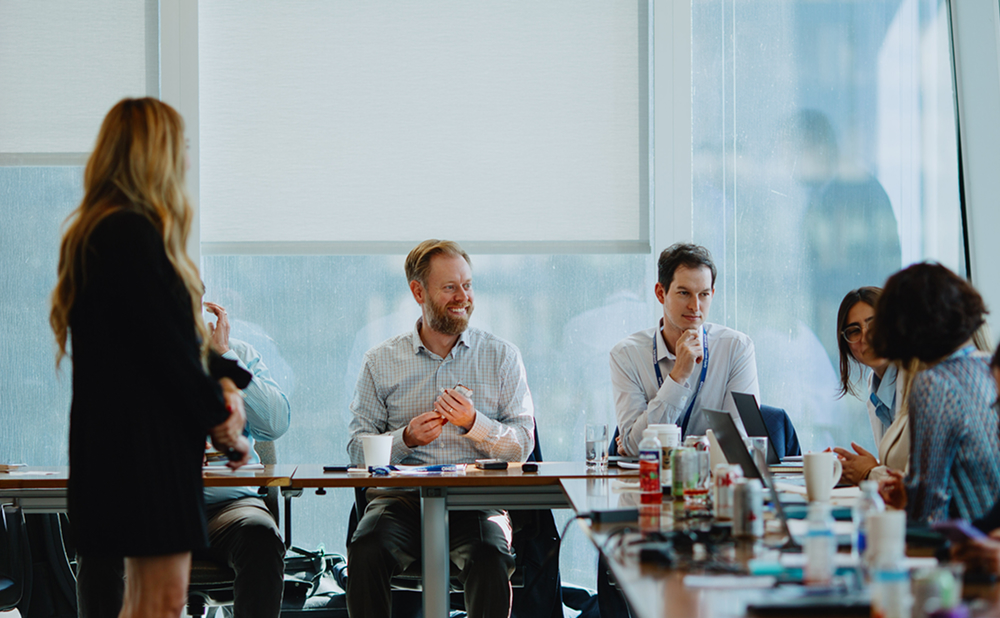 A group of people sitting in a meeting room