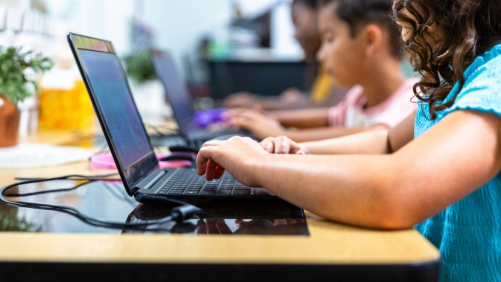 AI in school A child typing on a laptop