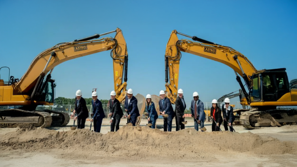 Groundbreaking at Alta A group of men and women in suits and hardhats shoveling dirt at the groundbreaking at Alta