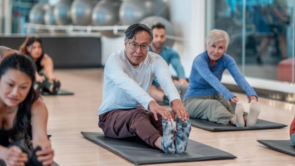 Community fitness Community fitness program with people stretching on yoga mats