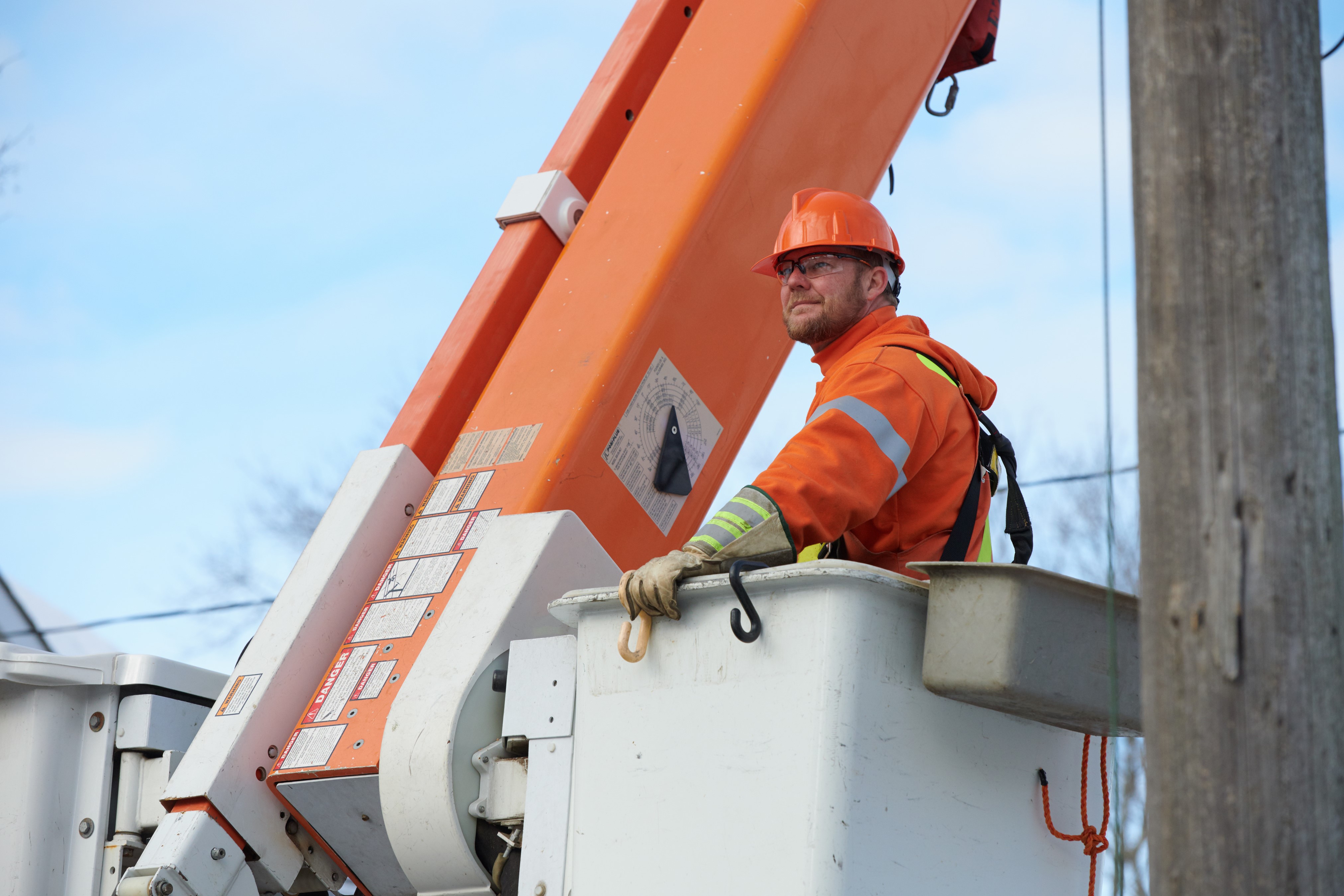 Newmarket-Tay Power Distribution Ltd 16 A Powerline worker in uniform in a company crane
