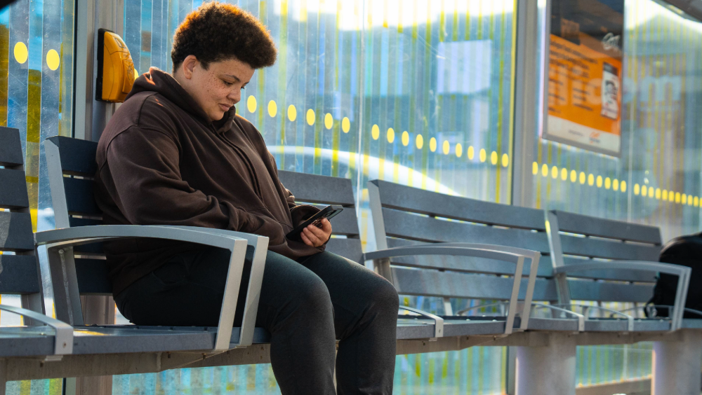 Burlington Transit A person sitting on a bench inside a transit station
