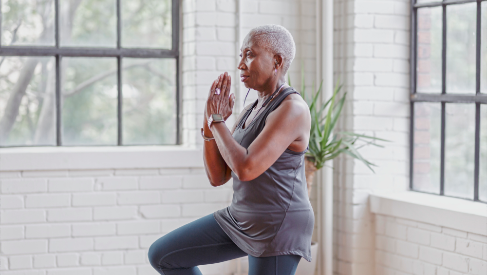 Four easy workouts for seniors A senior woman doing a yoga tree pose