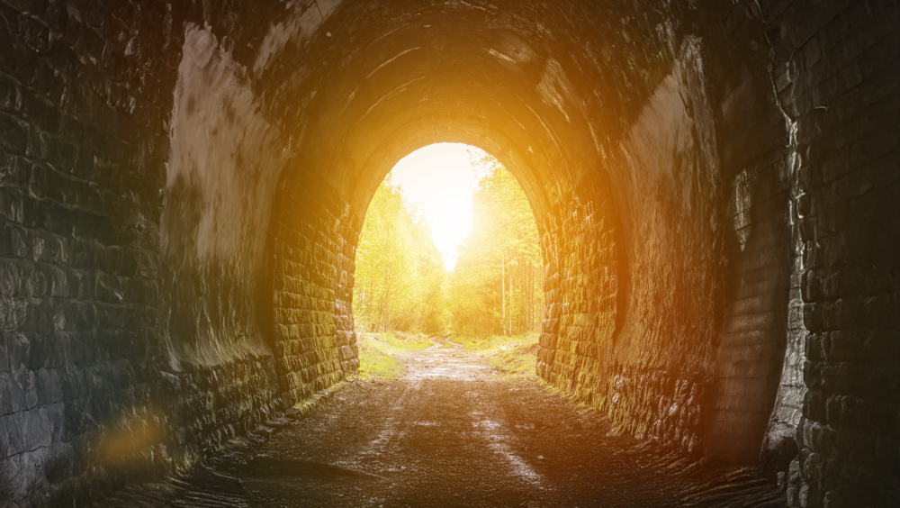 A light at the end of the tunnel Sunlight at the end of a brick tunnel