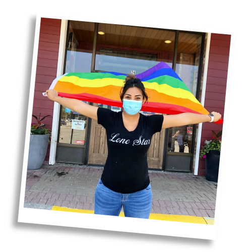 Lone Star employee holding a pride flag
