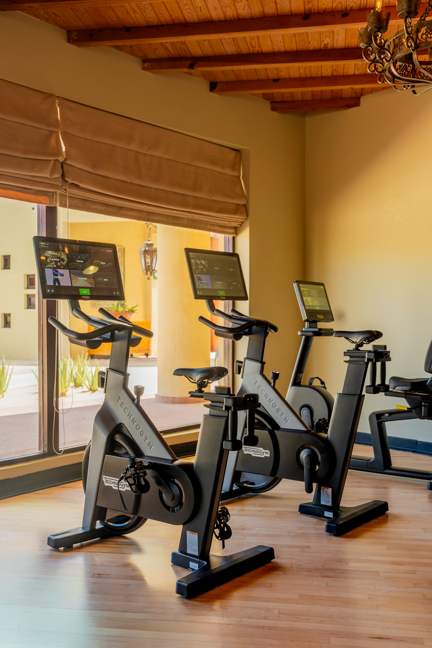 Technogym Bike smart stationary bikes in the fitness center at Waldorf Astoria Los Cabos Pedregal, offering connected cycling workouts in a luxury wellness environment