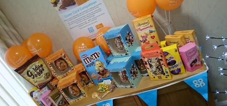 Balloons and a collection of easter eggs in a bright arrangement in a funeral home.