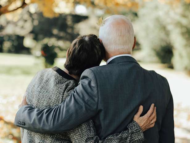 Two people hugging in a park