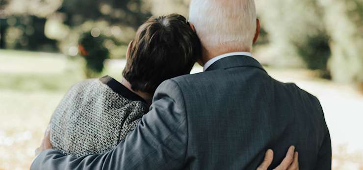 Two people hugging in a park