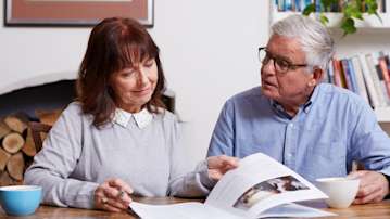 Couple reading funeral plan brochure