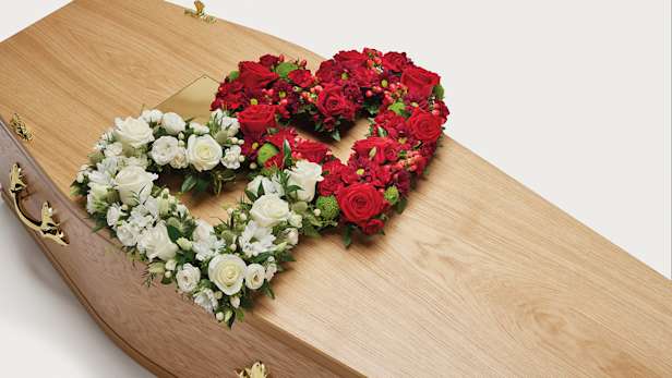 Red and white double heart shaped display on coffin