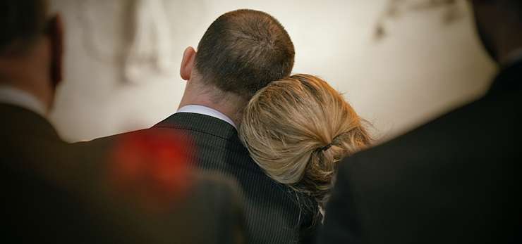 A man and woman leaning on each other.