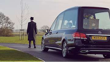Funeral director leading a funeral procession.