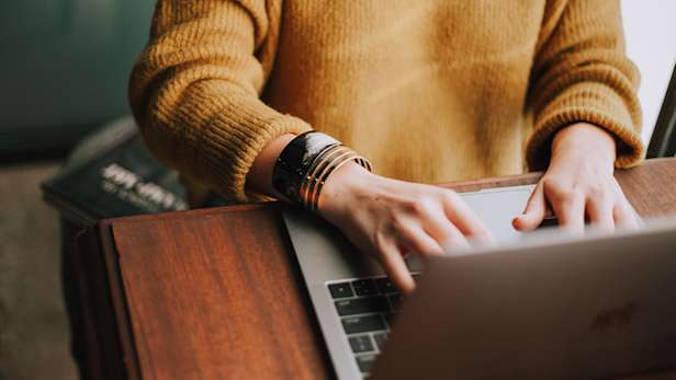 A woman using a laptop.