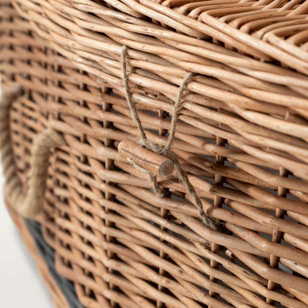 Close up of wicker coffin with cord handles and toggle fastening