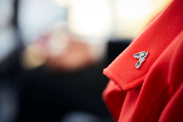 Football boots memory pin on a red coat