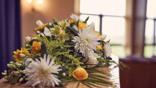 Coffin with floral spray on top