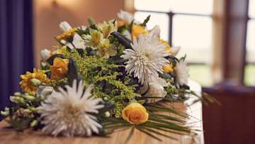 Coffin with floral spray on top