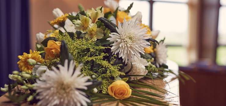 Coffin with floral spray on top