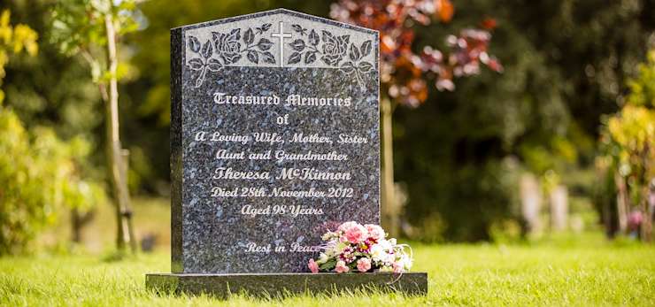 Headstone with roses and cross