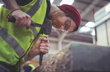 R4A9744 man using chisel on headstone