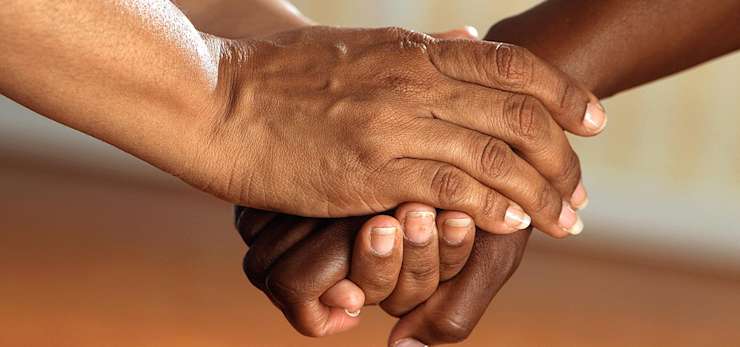 Two people holding hands