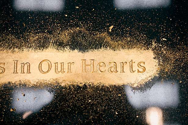 Image of gold engraving on a black granite headstone. Close up image. R4A0745