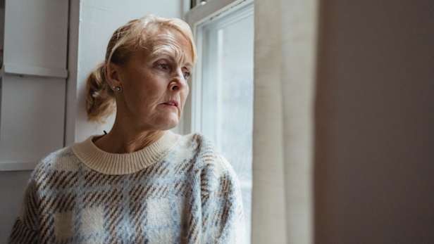 Woman looking out of window - Photo by Teona Swift from Pexels